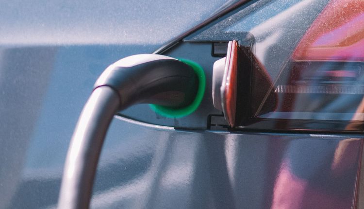 Electric vehicle plugged into a charger